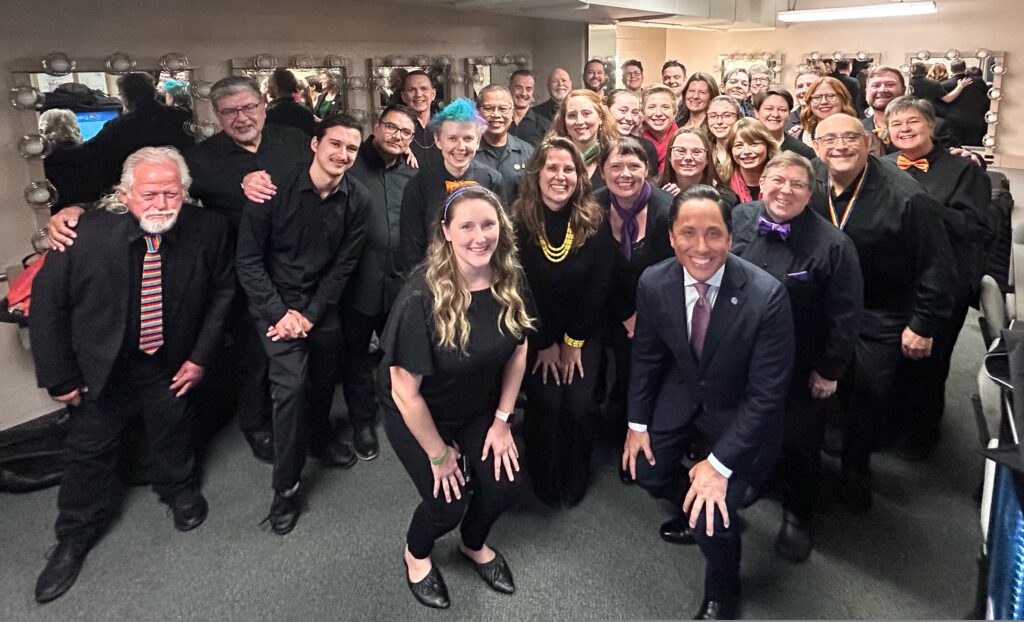 Members of San Diego Women's Chorus and San Diego Gay Men's Chorus pose with San Diego Mayor Todd Gloria